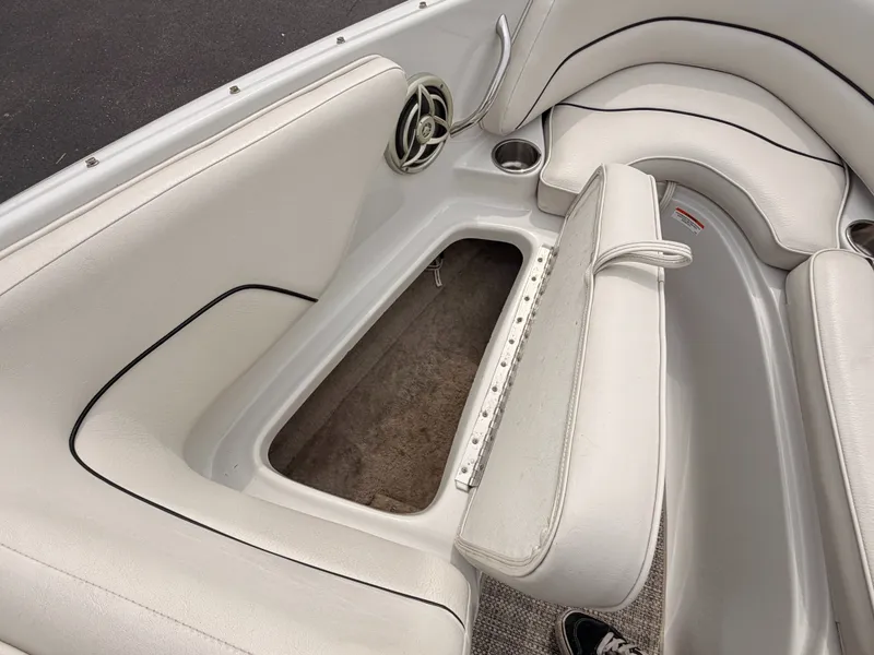 Slide: The Image of Interior of a 2009 Crownline 185 SS boat with white upholstery and storage compartment. - 44