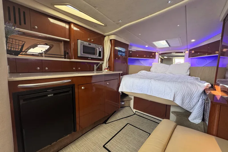 Slide: The Image of Luxurious interior of 2008 Sea Ray 350 Sundancer yacht with kitchenette and cozy bed. - 29