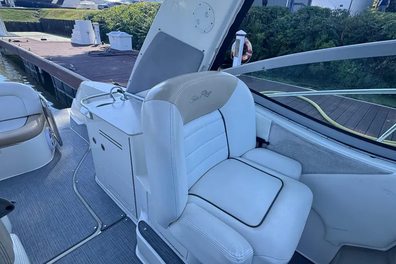 Slide: The Image of 2008 Sea Ray 350 Sundancer boat interior with white seating and helm station. - 26