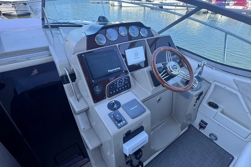 Slide: The Image of Cockpit of 2008 Sea Ray 350 Sundancer with steering wheel and navigation controls. - 18
