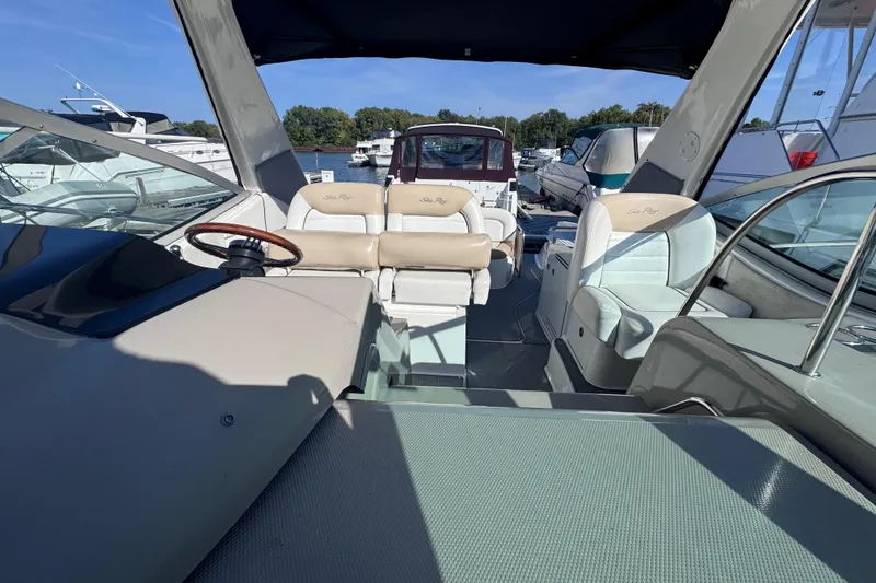 Slide: The Image of 2008 Sea Ray 350 Sundancer interior with helm and seating, docked at marina. - 23