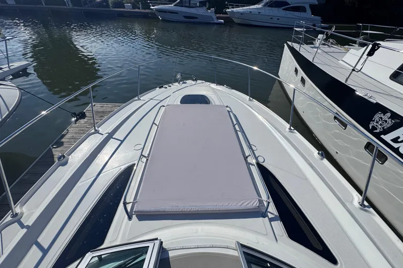 Slide: The Image of 2008 Sea Ray 350 Sundancer yacht docked, featuring spacious sunbathing area on deck. - 15