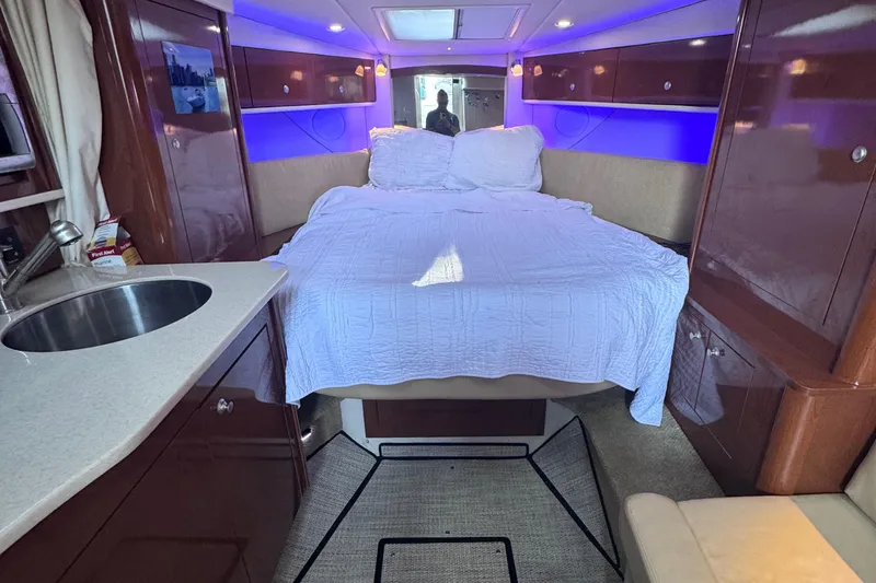 Slide: The Image of Interior of 2008 Sea Ray 350 Sundancer with bed, sink, and ambient lighting. - 33