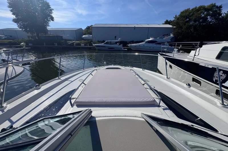 Slide: The Image of 2008 Sea Ray 350 Sundancer yacht docked in a marina under clear blue skies. - 16