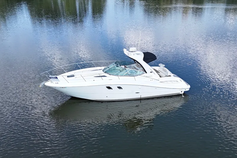 Slide: The Image of 2008 Sea Ray Sundancer 330 yacht on calm water, showcasing sleek design and luxury features. - 3