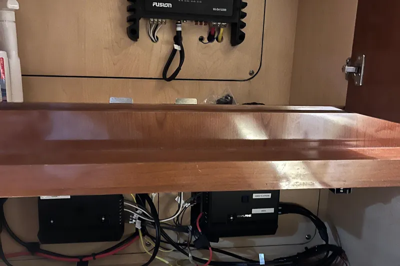 Slide: The Image of Interior view of a 2008 Sea Ray 350 Sundancer with electronic components and wiring. - 48