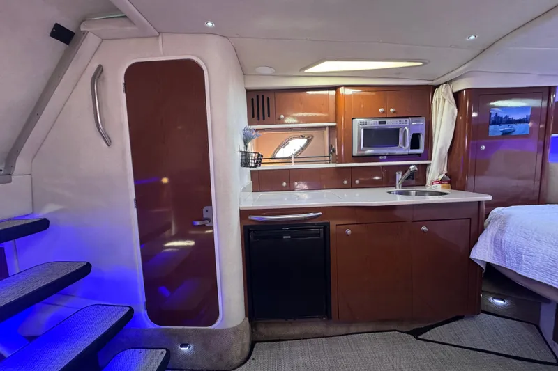Slide: The Image of Interior of 2008 Sea Ray 350 Sundancer yacht with kitchenette and modern amenities. - 42
