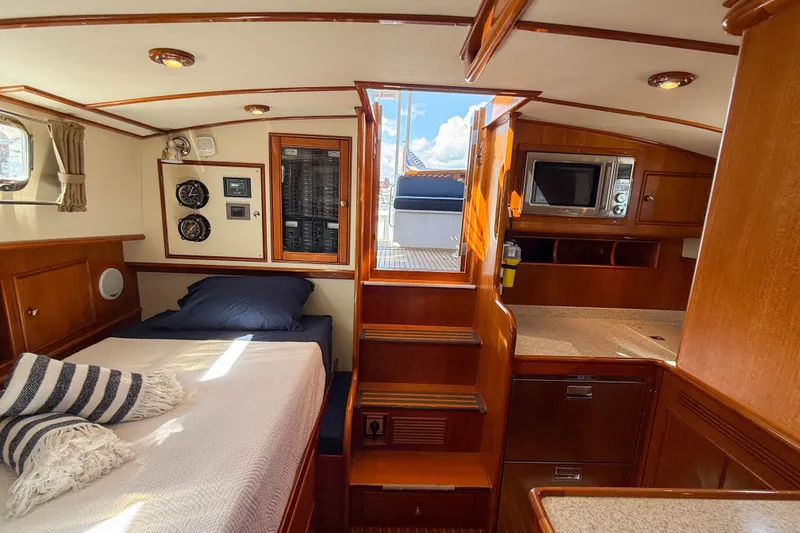 Slide: The Image of Interior of 2003 Grand Banks 38 Eastbay HX with bed, stairs, and kitchenette. - 33