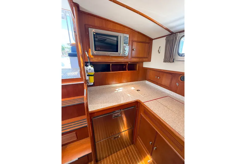 Slide: The Image of Interior of 2003 Grand Banks 38 Eastbay HX yacht with wooden cabinetry and modern appliances. - 22