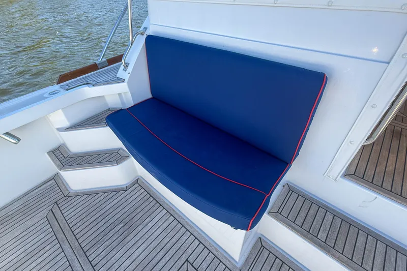 Slide: The Image of Blue cushioned seating on 2003 Grand Banks 38 Eastbay HX boat deck. - 5