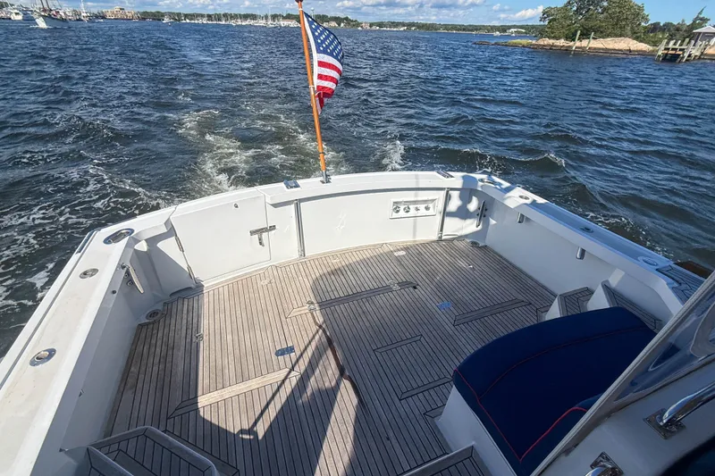 Slide: The Image of 2003 Grand Banks 38 Eastbay HX boat deck with American flag on open water. - 4