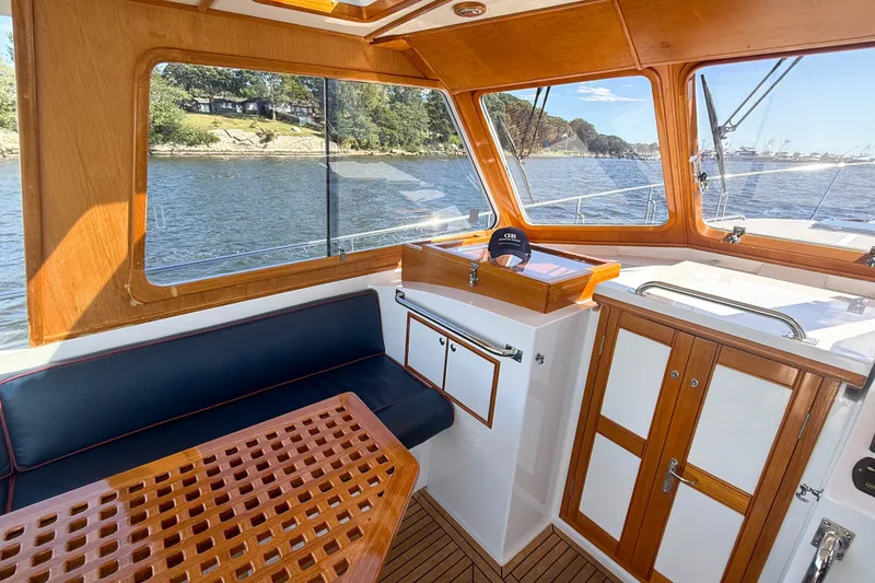 Slide: The Image of Interior of 2003 Grand Banks 38 Eastbay HX yacht with wood finish and waterfront view. - 8
