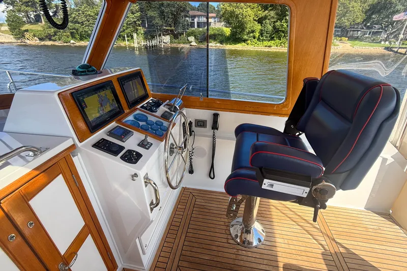 Slide: The Image of Helm of 2003 Grand Banks 38 Eastbay HX with navigation screens and captain's chair. - 11