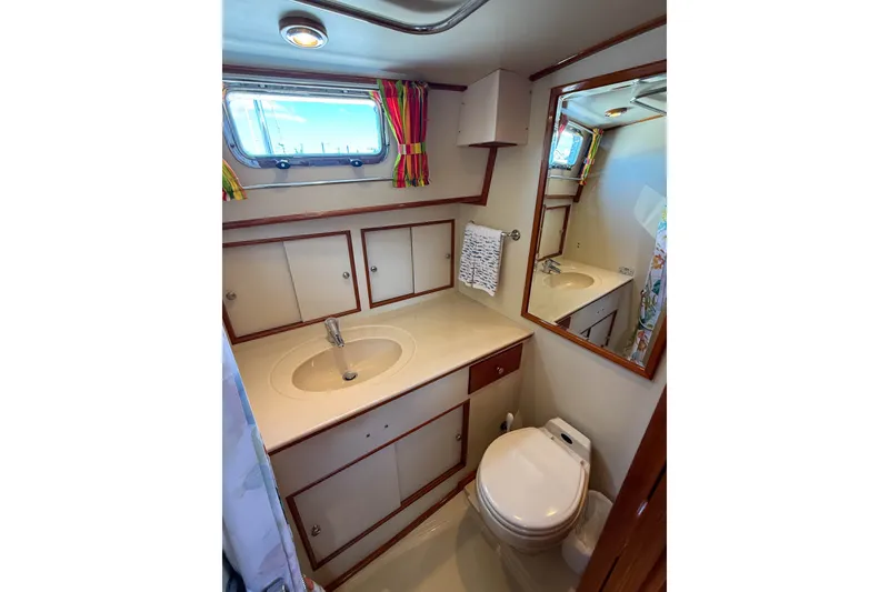 Slide: The Image of Bathroom interior of 2003 Grand Banks 38 Eastbay HX yacht, featuring sink, toilet, and window. - 32