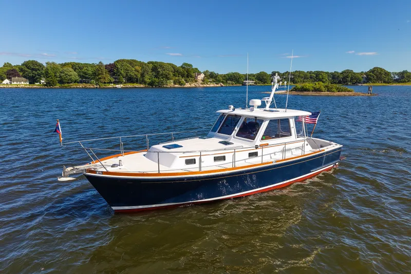 Slide: The Image of 2003 Grand Banks 38 Eastbay HX yacht cruising on a sunny day. - 1