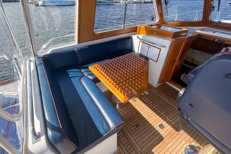 Slide: The Image of Interior of 2003 Grand Banks 38 Eastbay HX yacht with blue seating and wooden table. - 7