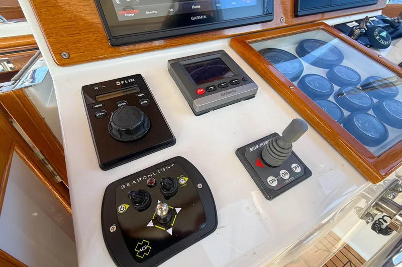 Slide: The Image of Control panel of a 2003 Grand Banks 38 Eastbay HX with navigation and searchlight controls. - 15