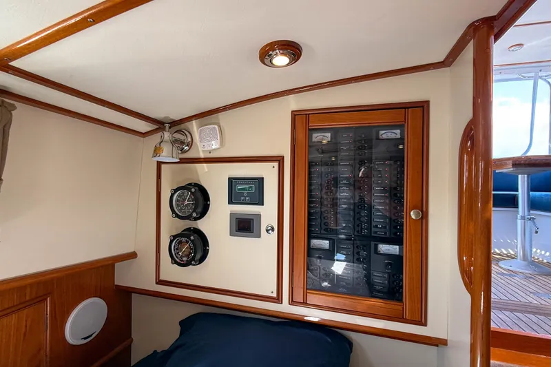 Slide: The Image of 2003 Grand Banks 38 Eastbay HX interior with control panel and gauges. - 26