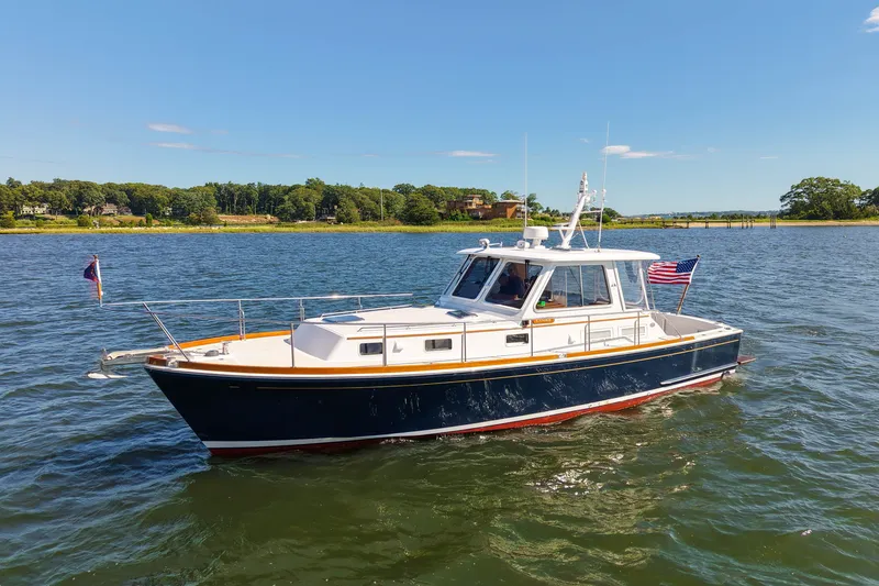The Image of 2003 Grand Banks 38 Eastbay HX yacht cruising on a sunny day. - 0