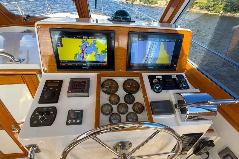 Slide: The Image of Helm of 2003 Grand Banks 38 Eastbay HX with navigation screens and controls. - 13
