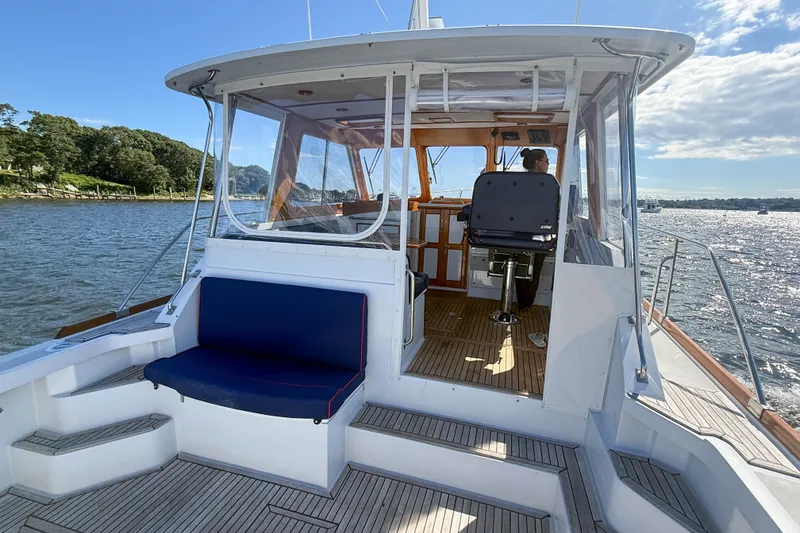Slide: The Image of 2003 Grand Banks 38 Eastbay HX yacht with open cockpit and scenic water view. - 3