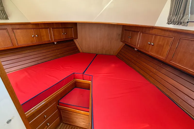 Slide: The Image of Interior cabin of 2003 Grand Banks 38 Eastbay HX with red bedding and wooden cabinets. - 27