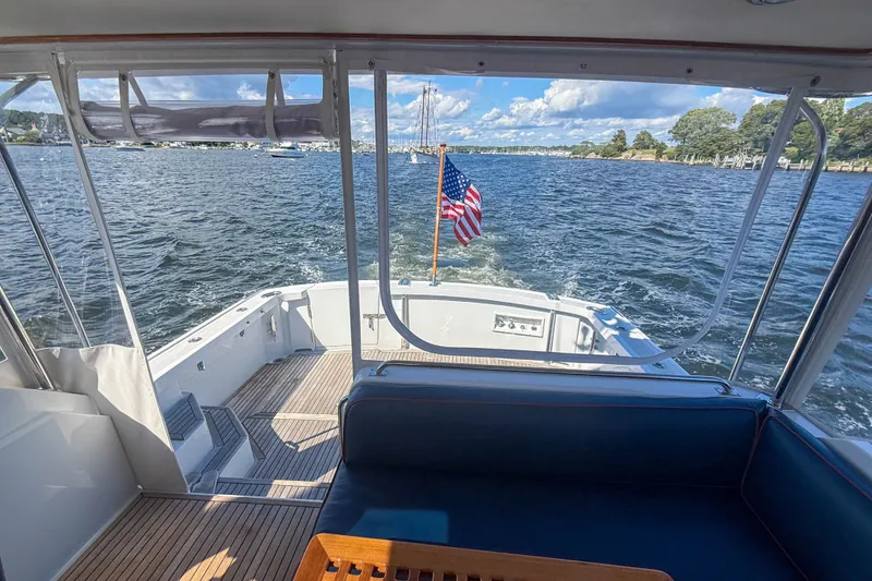 Slide: The Image of 2003 Grand Banks 38 Eastbay HX cruising on a sunny day with American flag. - 35