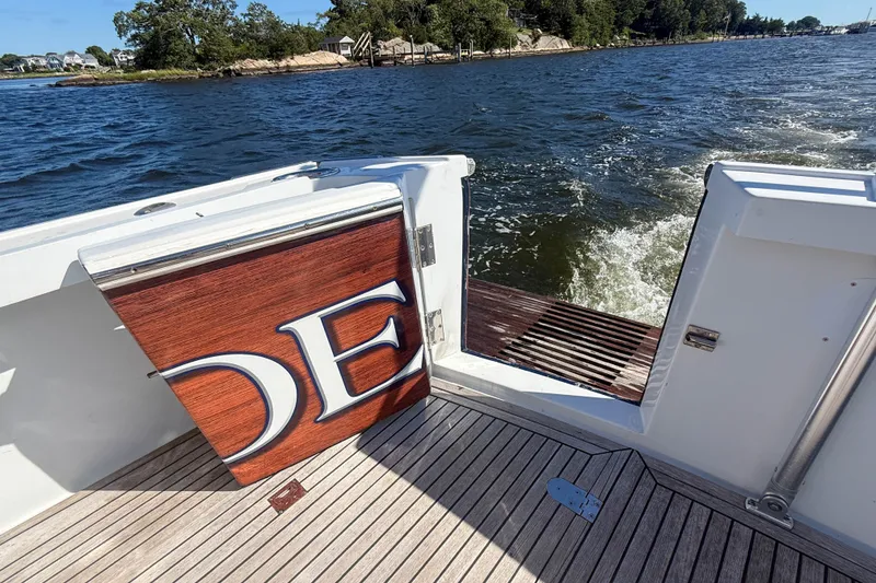 Slide: The Image of 2003 Grand Banks 38 Eastbay HX boat deck with open gate, overlooking water. - 44