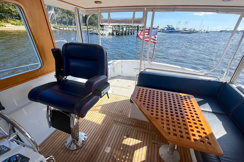 Slide: The Image of Interior of 2003 Grand Banks 38 Eastbay HX yacht with seating and wooden table. - 10