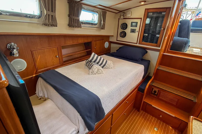 Slide: The Image of Luxurious cabin interior of 2003 Grand Banks 38 Eastbay HX yacht with cozy bed and wood finish. - 25