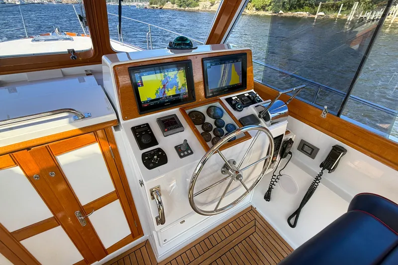 Slide: The Image of Helm of 2003 Grand Banks 38 Eastbay HX with navigation screens and steering wheel. - 12
