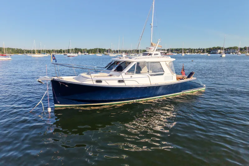 The Image of 2008 True North 34 boat on calm water with sailboats in the background. - 0