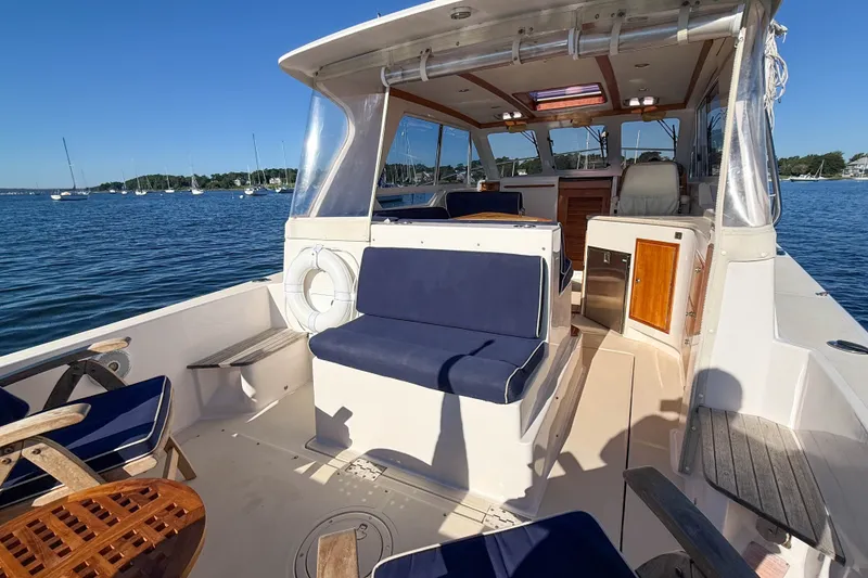 Slide: The Image of 2008 True North 34 boat interior with blue seating, wooden accents, and ocean view. - 7