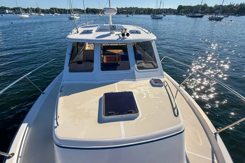 Slide: The Image of 2008 True North 34 boat on water, surrounded by sailboats, under clear sky. - 20