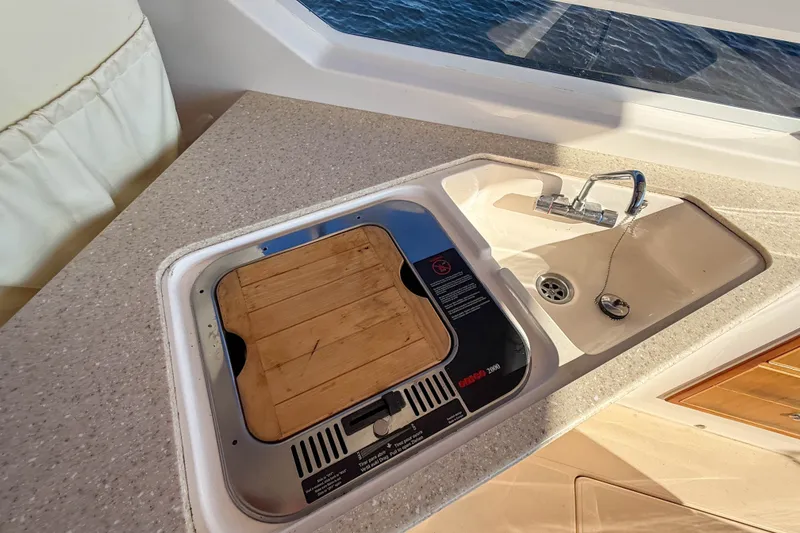 Slide: The Image of Compact kitchen area on a 2008 True North 34 boat with sink and stove. - 16