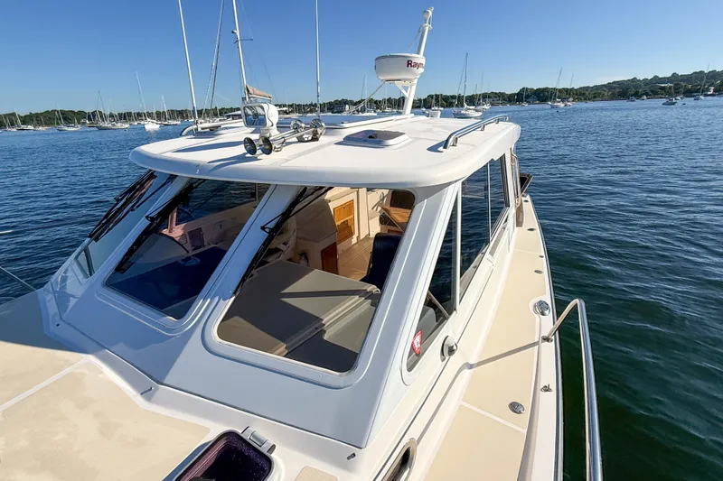 Slide: The Image of 2008 True North 34 boat on calm water, showcasing sleek design and spacious cabin. - 22