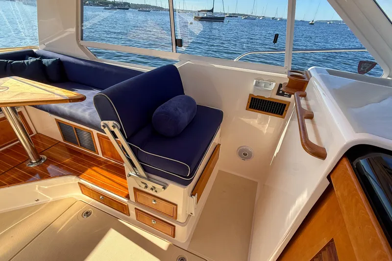 Slide: The Image of Interior of 2008 True North 34 boat with blue seating and wooden accents. - 10
