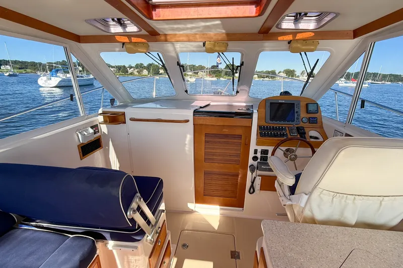 Slide: The Image of Interior of 2008 True North 34 boat with helm, seating, and scenic water view. - 8