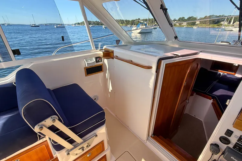 Slide: The Image of Interior of 2008 True North 34 boat with blue seating and wooden cabinetry. - 42