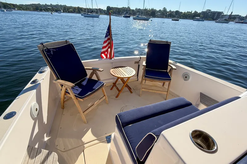 Slide: The Image of Cozy seating area on 2008 True North 34 boat, overlooking serene marina waters. - 43