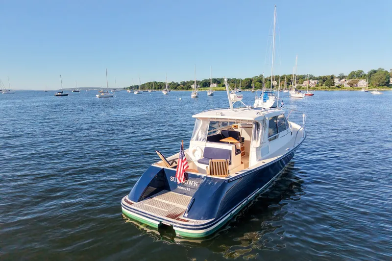 Slide: The Image of 2008 True North 34 boat anchored in a scenic harbor with other vessels. - 4