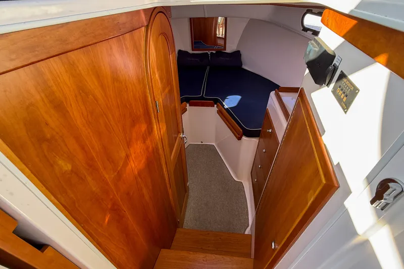 Slide: The Image of Interior cabin of 2008 True North 34 boat with wooden finishes and cozy sleeping area. - 27