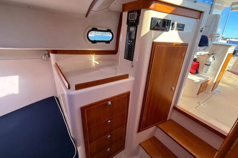 Slide: The Image of 2008 True North 34 yacht interior with wooden cabinetry and seating area. - 30