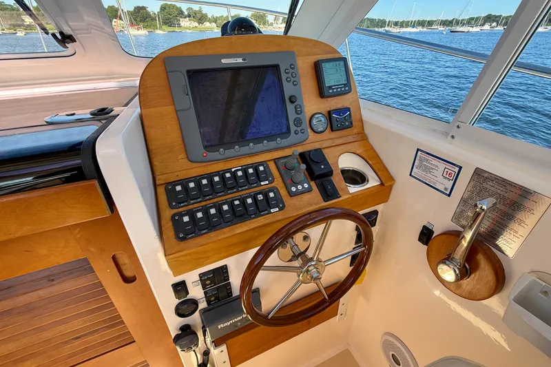Slide: The Image of Helm of 2008 True North 34 boat with navigation controls and scenic water view. - 12