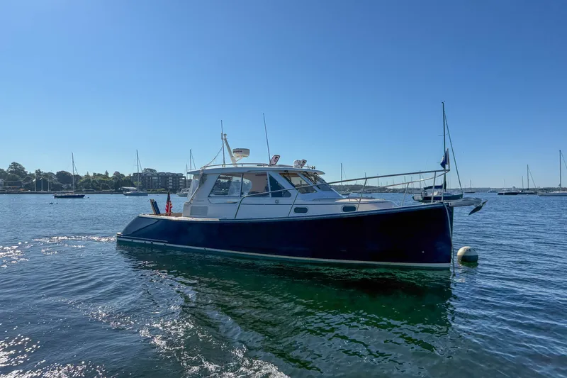 Slide: The Image of 2008 True North 34 boat on calm water under clear blue sky. - 5