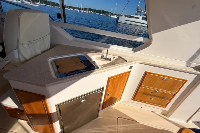 Slide: The Image of Interior of 2008 True North 34 boat with kitchenette and scenic marina view. - 15