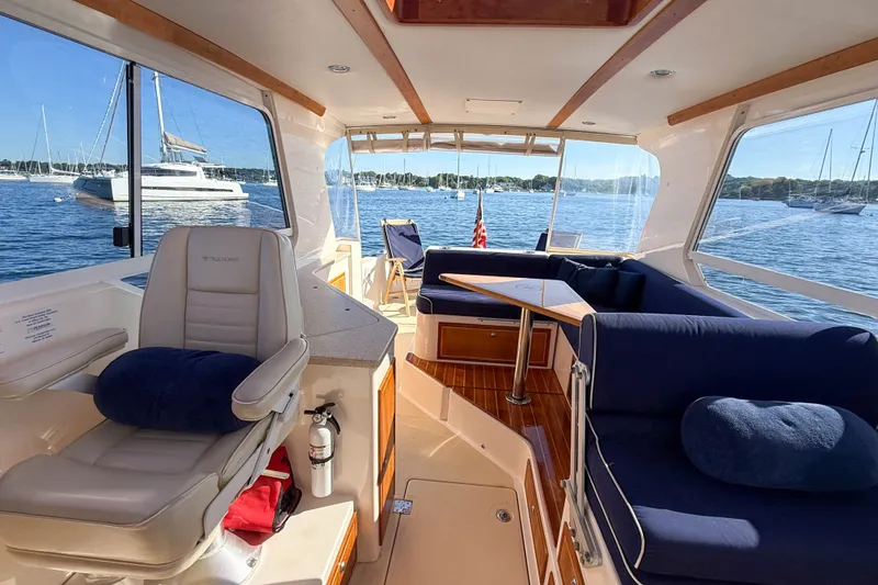 Slide: The Image of Interior of 2008 True North 34 yacht with seating, table, and scenic water view. - 32