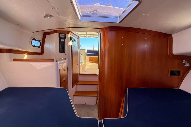 Slide: The Image of Interior of 2008 True North 34 boat with wooden finishes and blue seating. - 31