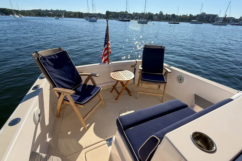 Slide: The Image of Cozy seating area on 2008 True North 34 boat with scenic harbor view. - 38