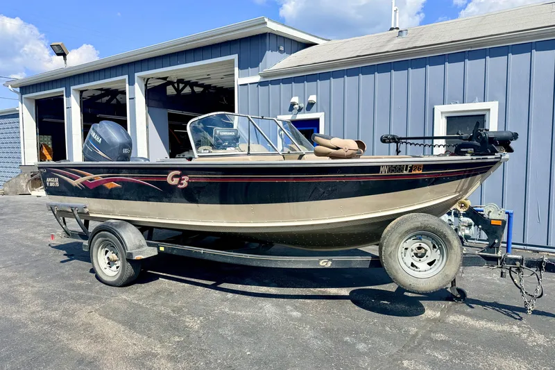 Slide: The Image of 2008 G3 Angler V185 FS boat on trailer, parked outside a blue building. - 7